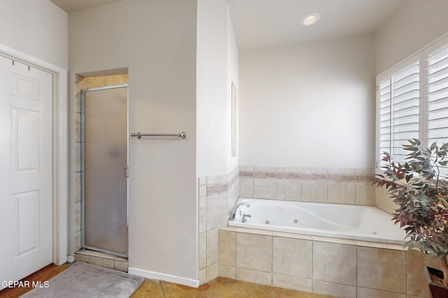 full bathroom with a whirlpool tub, a stall shower, and tile patterned flooring