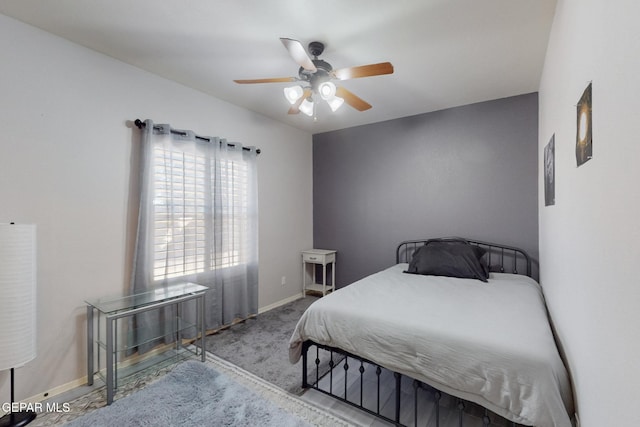 bedroom featuring baseboards, a ceiling fan, and light colored carpet