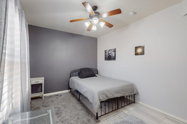 bedroom with ceiling fan and baseboards