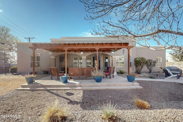 back of house with a patio area and stucco siding