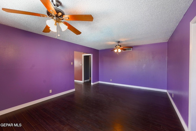 empty room with a textured ceiling, dark hardwood / wood-style floors, and ceiling fan