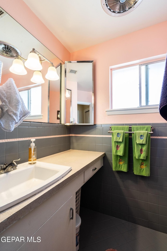 bathroom featuring tile walls and vanity