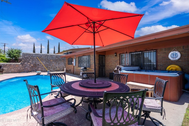 view of pool with a hot tub, a patio, a diving board, and exterior bar