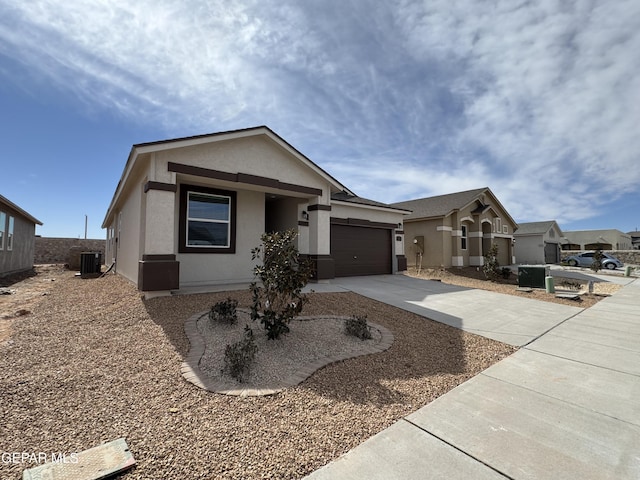 view of front of property featuring a garage and central air condition unit