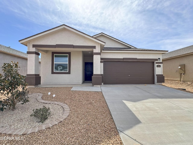 single story home with driveway, an attached garage, and stucco siding