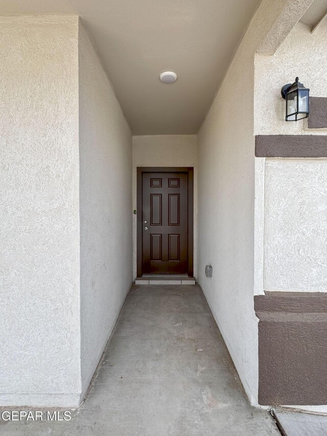 view of exterior entry with stucco siding