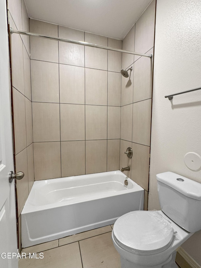 full bath featuring toilet, tile patterned flooring, and shower / bathing tub combination