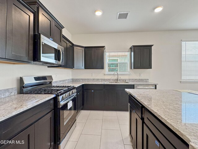 kitchen featuring recessed lighting, visible vents, appliances with stainless steel finishes, light tile patterned flooring, and a sink