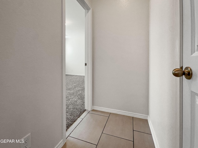 hallway with light carpet and baseboards