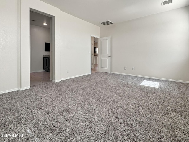 interior space featuring carpet floors, baseboards, and visible vents