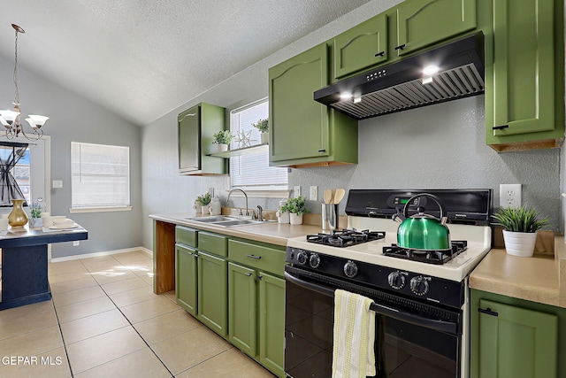 kitchen with gas range oven, range hood, light countertops, and a sink