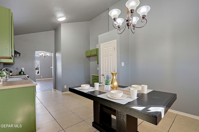 dining room with baseboards, a notable chandelier, and light tile patterned flooring