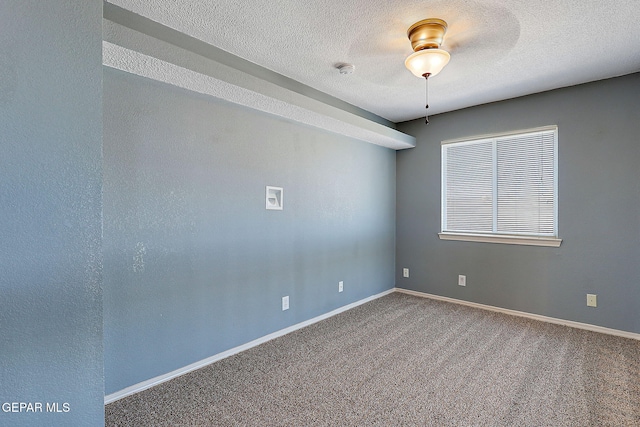 unfurnished room with carpet floors, baseboards, and a textured ceiling