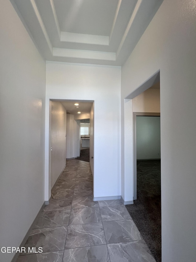 14916 Concept Ct, El Paso, TX 79938 - corridor featuring baseboards, marble look tiles, and a raised ceiling