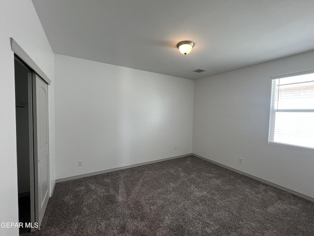 14916 Concept Ct, El Paso, TX 79938 - unfurnished bedroom featuring dark carpet, baseboards, and a closet