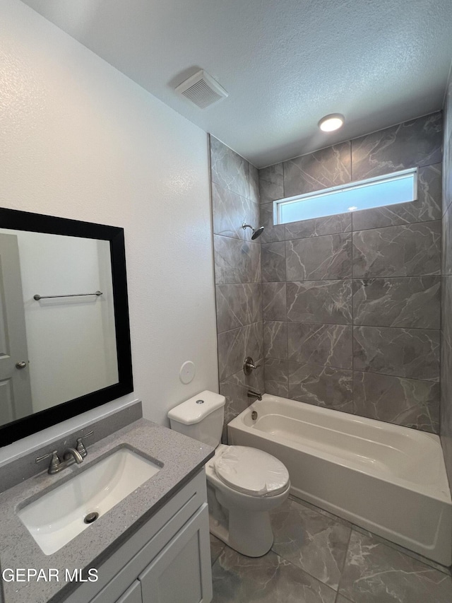 14916 Concept Ct, El Paso, TX 79938 - full bathroom featuring  shower combination, vanity, toilet, marble look tiles, and a textured ceiling