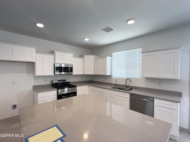 14916 Concept Ct, El Paso, TX 79938 - kitchen with stainless steel appliances, a sink, white cabinetry, recessed lighting, and stone counters