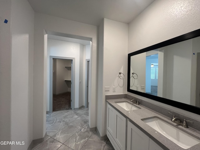 14916 Concept Ct, El Paso, TX 79938 - bathroom featuring marble finish floors, double vanity, and baseboards