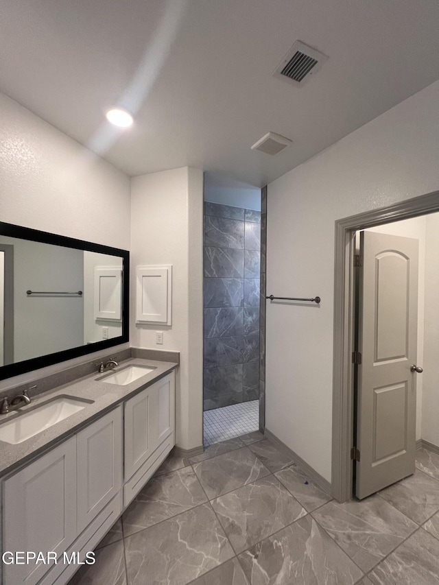 14916 Concept Ct, El Paso, TX 79938 - bathroom featuring marble finish flooring, walk in shower, double vanity, and baseboards