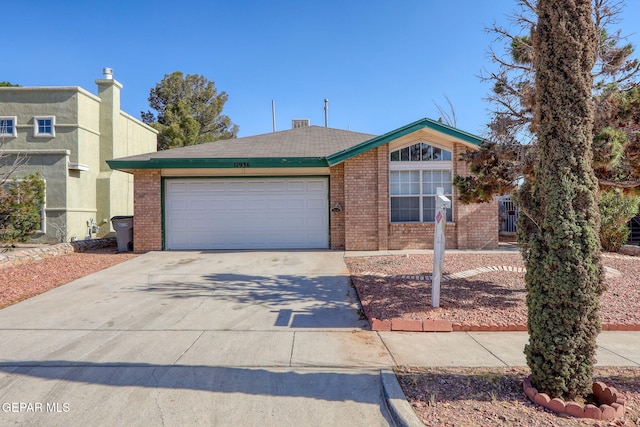 view of front of property featuring an attached garage, concrete driveway, and brick siding