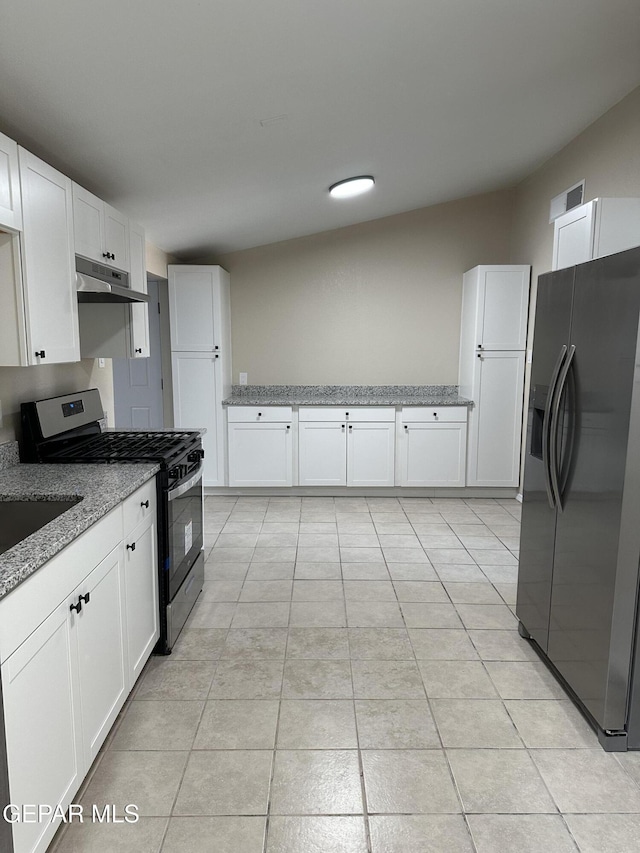 kitchen featuring white cabinetry, fridge with ice dispenser, light stone countertops, under cabinet range hood, and stainless steel gas range oven