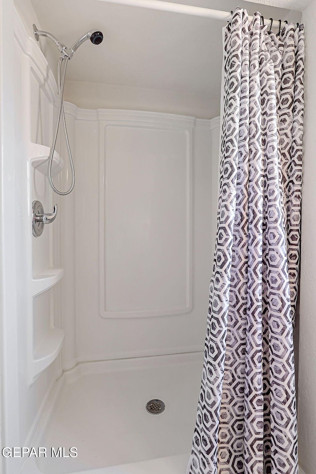 bathroom with a shower stall