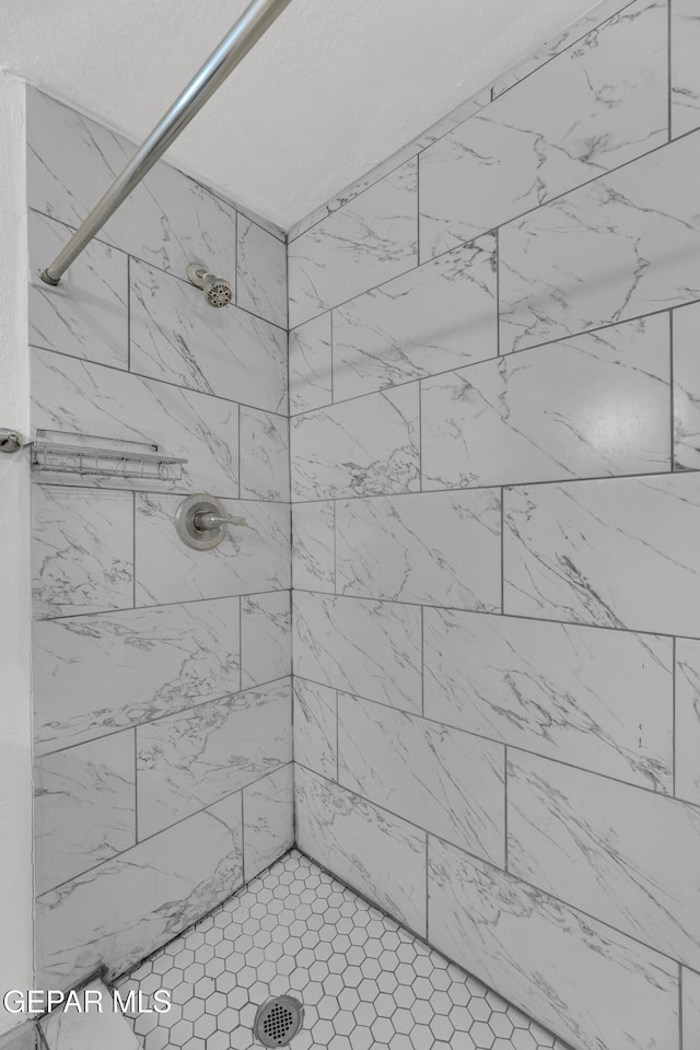 bathroom with tiled shower