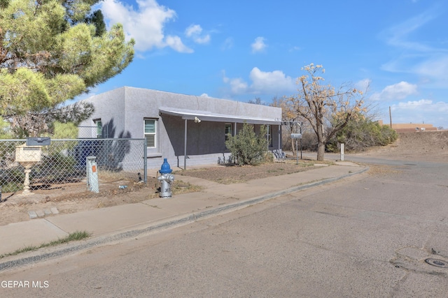 southwest-style home with fence and stucco siding