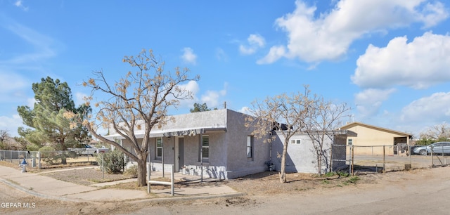 view of front facade with a fenced front yard and stucco siding