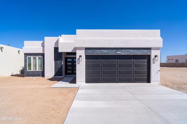 view of front facade featuring concrete driveway and stucco siding