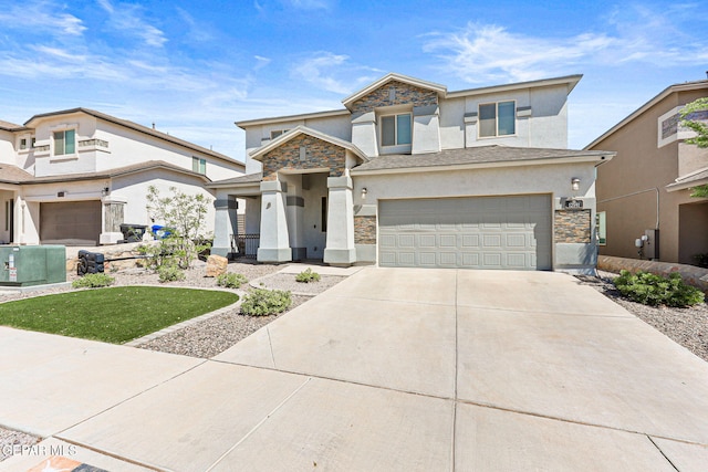 view of front facade with a garage, driveway, stone siding, and stucco siding