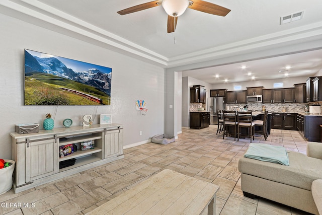 living area with ceiling fan, baseboards, visible vents, and recessed lighting