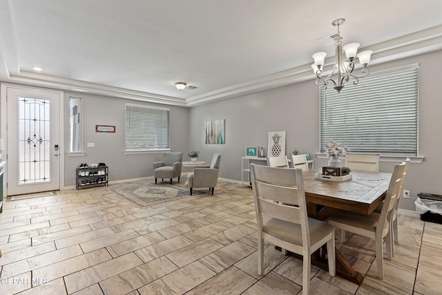 dining area featuring a tray ceiling, visible vents, baseboards, and an inviting chandelier
