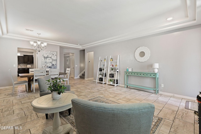 living room featuring baseboards, a notable chandelier, visible vents, and a raised ceiling