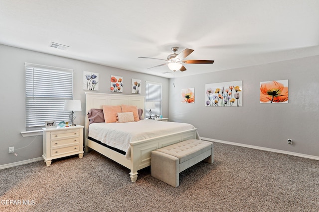 carpeted bedroom with visible vents, baseboards, and ceiling fan