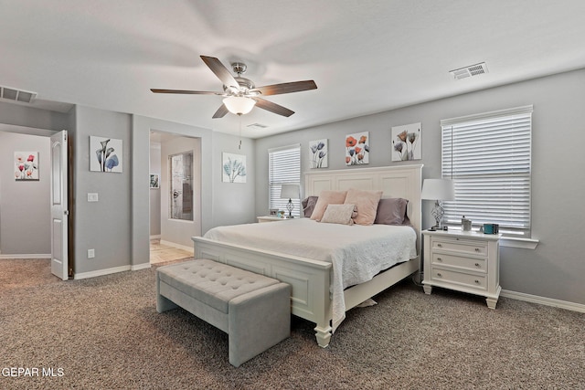 carpeted bedroom featuring baseboards, visible vents, and ceiling fan