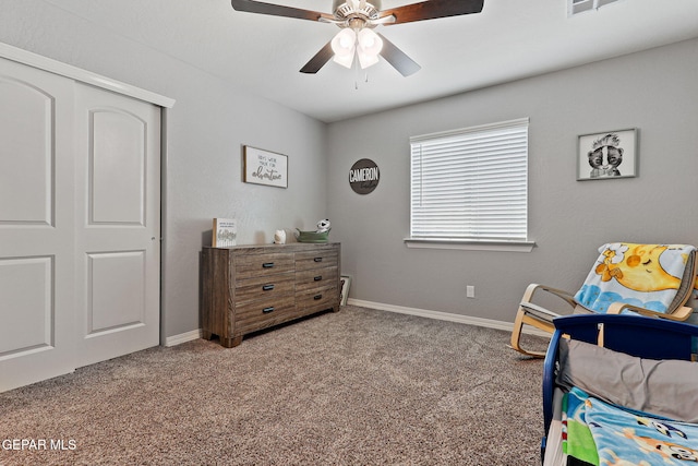 carpeted bedroom featuring baseboards, a ceiling fan, visible vents, and a closet