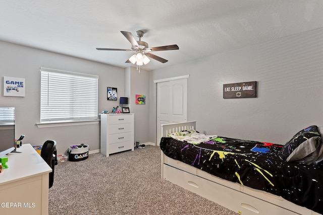 bedroom featuring baseboards, light colored carpet, and ceiling fan