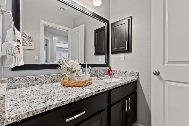 bathroom featuring visible vents and vanity