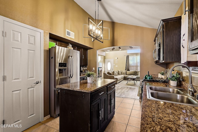 kitchen featuring a center island, pendant lighting, stainless steel appliances, visible vents, and a sink