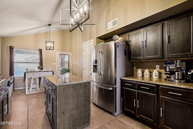 kitchen featuring pendant lighting, visible vents, dark brown cabinets, and stainless steel fridge with ice dispenser