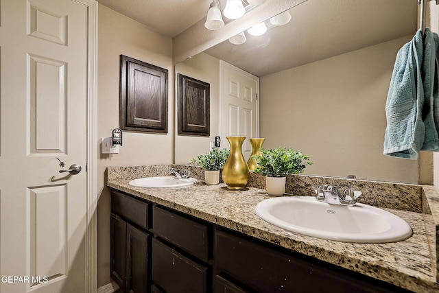 full bath with double vanity and a sink