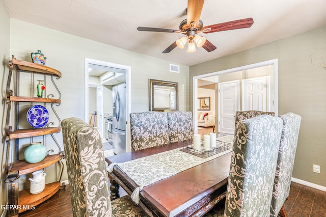 dining room featuring ceiling fan, dark wood-style flooring, visible vents, and baseboards