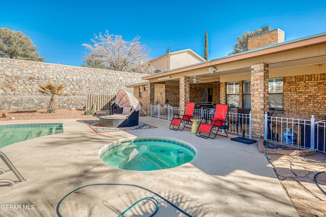 view of swimming pool with a patio area, a fenced backyard, an outdoor bar, and an in ground hot tub