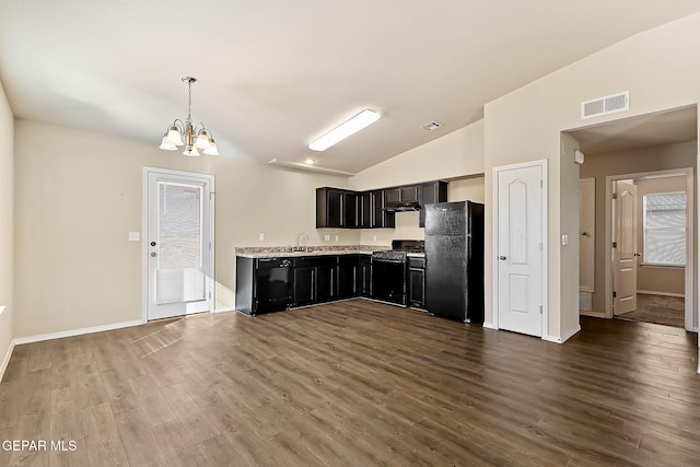 kitchen with a notable chandelier, wood finished floors, a sink, visible vents, and black appliances