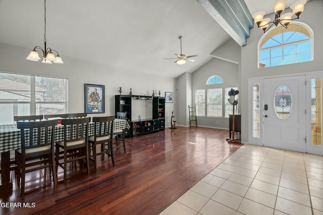 foyer featuring beam ceiling, wood finished floors, high vaulted ceiling, baseboards, and ceiling fan with notable chandelier