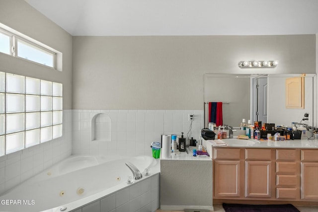 bathroom with a whirlpool tub and vanity