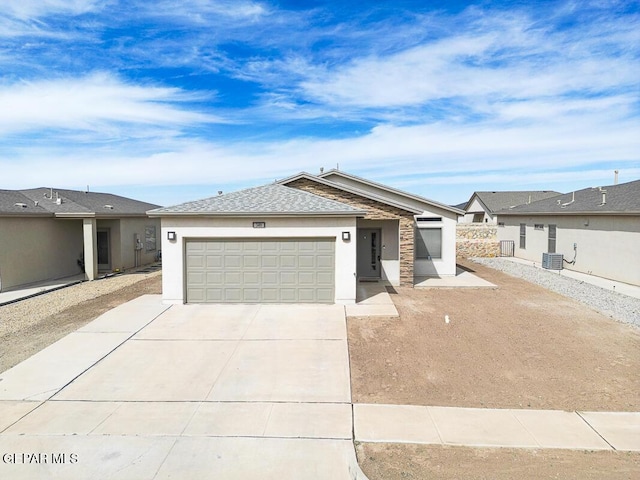 single story home with a garage, central AC unit, concrete driveway, and stucco siding