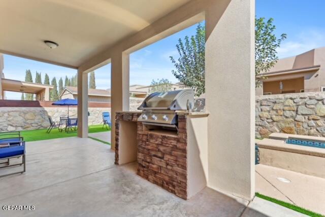 view of patio / terrace featuring area for grilling, grilling area, and fence