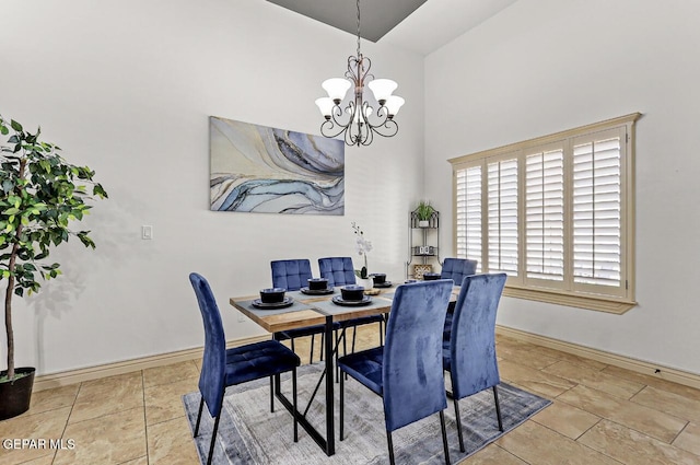 dining space with a notable chandelier, baseboards, and tile patterned floors